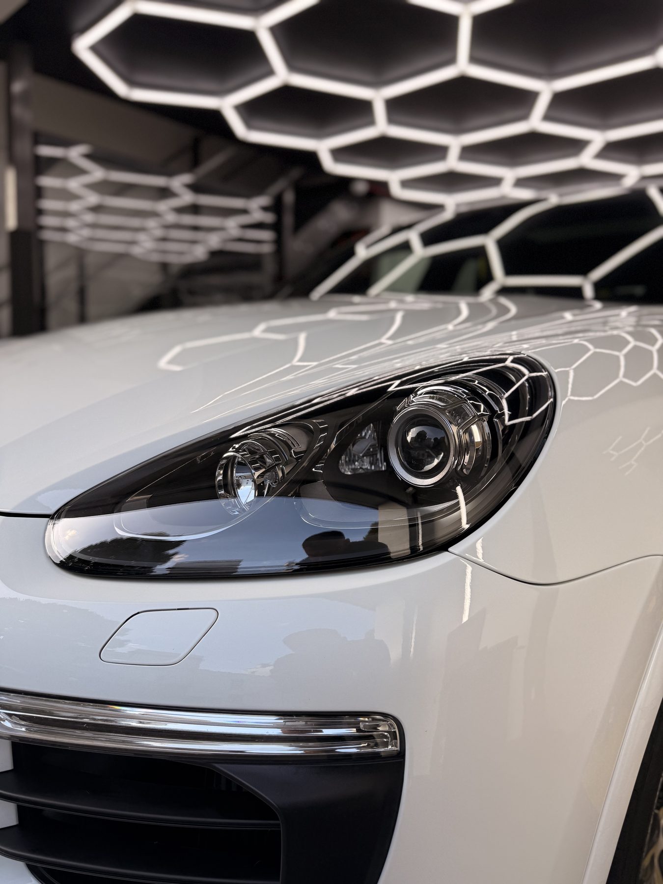 Close-up of polished headlight and paintwork after paint correction